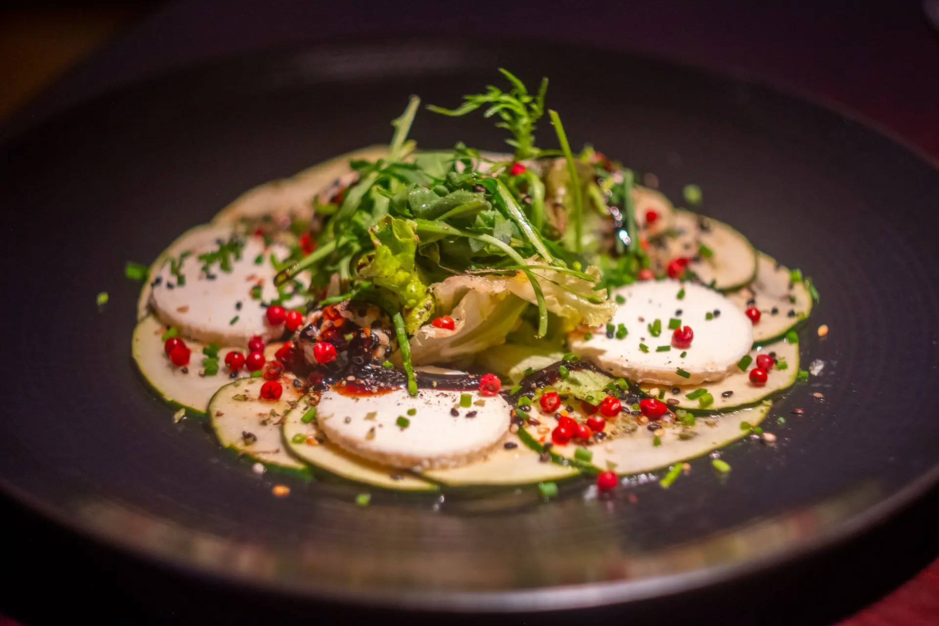 This exquisite zucchini carpaccio, delicately layered with fresh goat cheese, aromatic herbs, and a drizzle of fine olive oil, is a testament to refined Mediterranean flavors. Captured by Louis Mas, a food photographer and videographer in Barcelona, this vibrant dish is perfect for restaurant branding and digital marketing, showcasing fresh, high-quality ingredients in an elegant presentation.