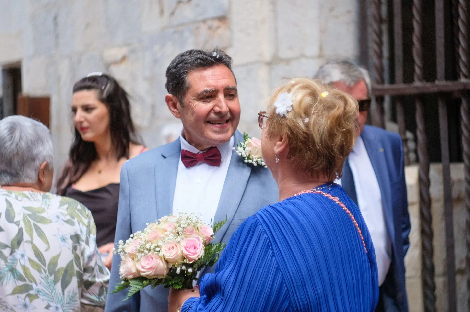 This photograph captures a fleeting yet eternal moment—the groom’s loving gaze as he admires his newlywed wife just outside the city hall. The photographer masterfully plays with natural light and composition, framing the couple in a way that feels intimate yet universal. The slight blur of the background enhances the focus on emotion, making the viewer feel like a quiet witness to this fresh chapter of their lives. The authenticity in their expressions, paired with the organic movement of the scene, demonstrates a keen eye for storytelling—one that turns a simple glance into a timeless memory.